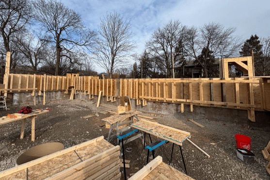 Wooden formwork for concrete foundation walls is erected at the Field Park construction site.