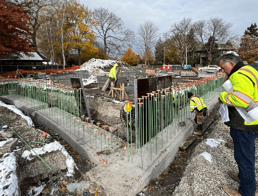 Construction workers prepare rebar and concrete forms for the Field Park building foundation.