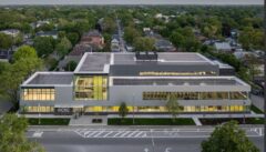 Aerial view of the Community Recreation Center (facilities_dir_ltg) with solar panels on the roof and large windows.