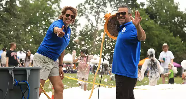 Park District staff greeting visitors during an outdoor community foam event.