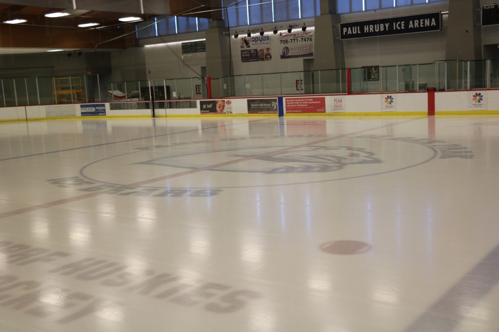 The Paul Hrube Ice Arena features a clean ice surface with the 'Dorf Huskies' logo and team name visible.