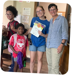 Participants posing together during a Park District youth program, with one participant holding a certificate.