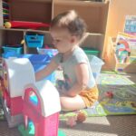 young child plays with toys at the cubhouse indoor playground