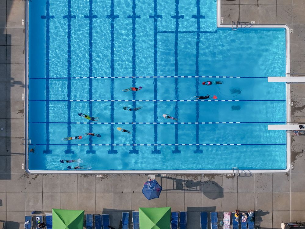 an aerial image of ridgeland pool with swimmers doing laps with kickboards
