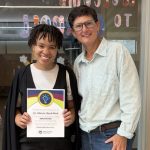 a seasonal staff holds their everyday values champion certificate and poses for a photo with the park district executive director